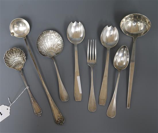 A French silver sifter spoon with scallop shaped bowl and eight pieces of plated French cutlery (9)